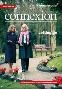 front cover of magazine, showing two women walking together